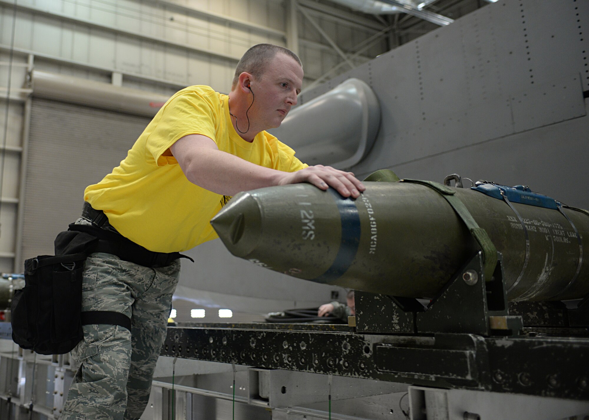 Airman 1st Class Damian Wiseman, 28th Aircraft Maintenance Squadron weapons load crew member, right, is congratulated by Senior Master Sgt. Justin Price, 28th AMXS weapons flight chief, after winning a quarterly load crew competition at Ellsworth Air Force Base, S.D., Jan. 29, 2016. The groups were evaluated on technical procedures, safety and reliability issues. (U.S. Air Force photo by Airman Donald Knechtel/Released)