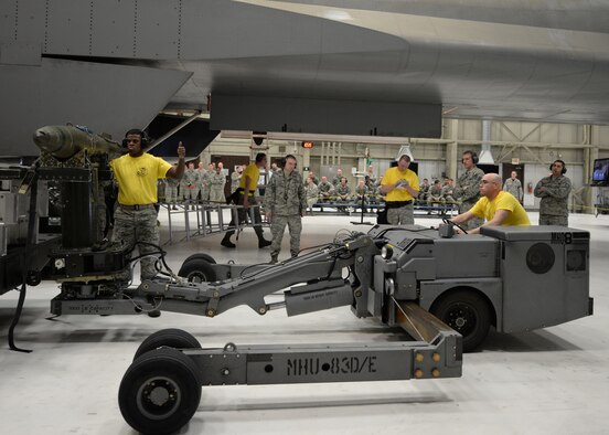 Airmen of the 28th Aircraft Maintenance Squadron participate in a load crew of the quarter competition at Ellsworth Air Force Base, S.D., Jan. 29, 2016. The 34th and 37th Aircraft Maintenance Units displayed their skills during a 25-minute loading challenge, which included a quiz, tool box setup evaluation and uniform inspections. The victors this quarter were the Airmen from the 37th AMU. (U.S. Air Force photo by Airman Sadie Colbert/Released)