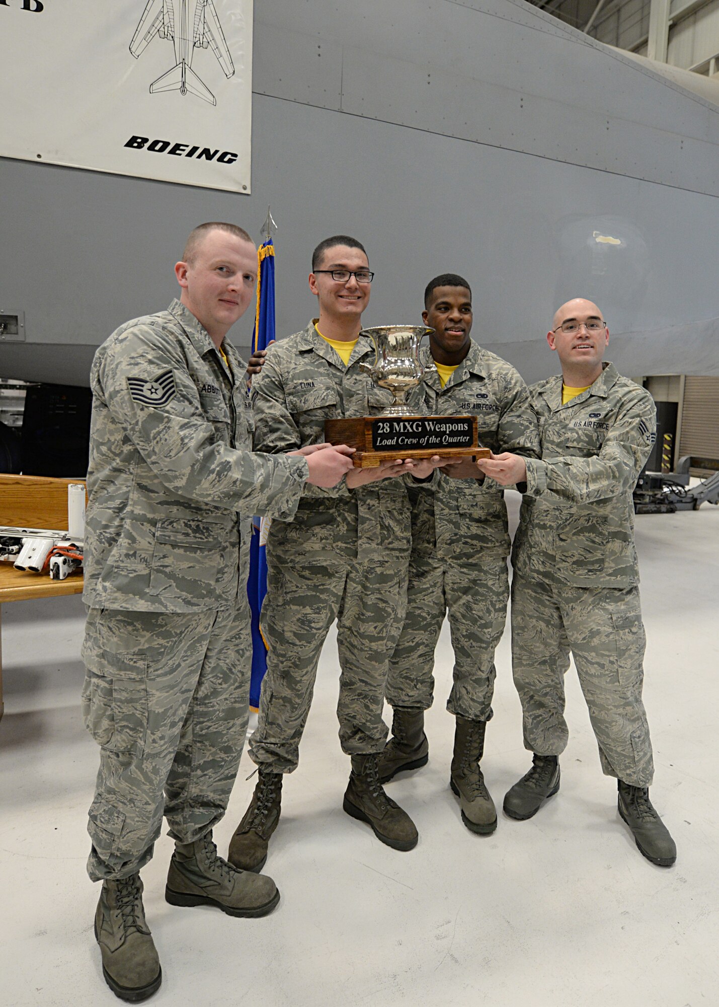 Airmen from 37th Aircraft Maintenance Unit clinched victory during a weapons load crew quarterly competition, Jan. 29.

Various load crews from the 28th Bomb Wing showcased their skills by racing against time to load explosives on a mock B-1 bomber accurately and safely.

"The competition shows how well we are prepared to load up a jet as fast and safely as we can to complete the mission that needs to be done," said Airman 1st Class Ignacio Luna, 28th Aircraft Maintenance Squadron weapons load crew member. "The biggest challenge we faced was that we were up against a crew that was far more experienced than we are, so we were the underdogs."

Though the 37th AMU were not favorites of the competition, they worked together and got the job done.

"Weapons load competitions build team work and unit camaraderie," said Tech. Sgt. Harold VanderMolen, 28th MXG loading standardization crew team chief. "They also provide the winning unit recognition for their hard work and the pride of showcasing the 28th BW Load Crew of the Quarter trophy in their unit."

The Loading Standardization Crew evaluates each load crew unit competing on performing safe and reliable weapons loading operations in accordance with B-1 bomber weapons loading technical orders, and Air Force instructions. The load crew members were required to load two 500 pound Mk-82 general purpose bombs, and one Guided Bomb Unit 31v3 within a strict 25-minute time standard.

VanderMolen added these competitions are serious business and crews dedicate time prior to ensure their best performance.

"Crews will come down to the Weapons Standardization area and practice the load," VanderMolen said. "They'll inspect the munitions and equipment prior to load competition day to ensure nothing will be missed. It's easy to read it in a book, but it is a whole different story actually performing it."

Though the event offers team and morale building, the competition tests the Airmen's knowledge and skills by pushi