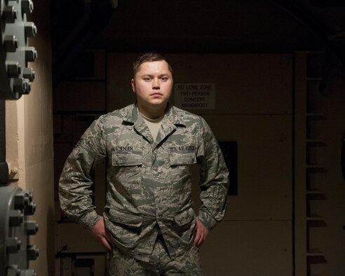 Staff Sgt. Jerimiah Jensen, 320th Missile Squadron facility manager, poses for a portrait in the tunnel junction of a missile alert facility belonging to F.E. Warren Air Force Base, Jan. 28, 2016. Facility managers  keep missile alert facilities in operation order for the nuclear deterrent mission. (U.S. Air Force photo by Lan Kim)