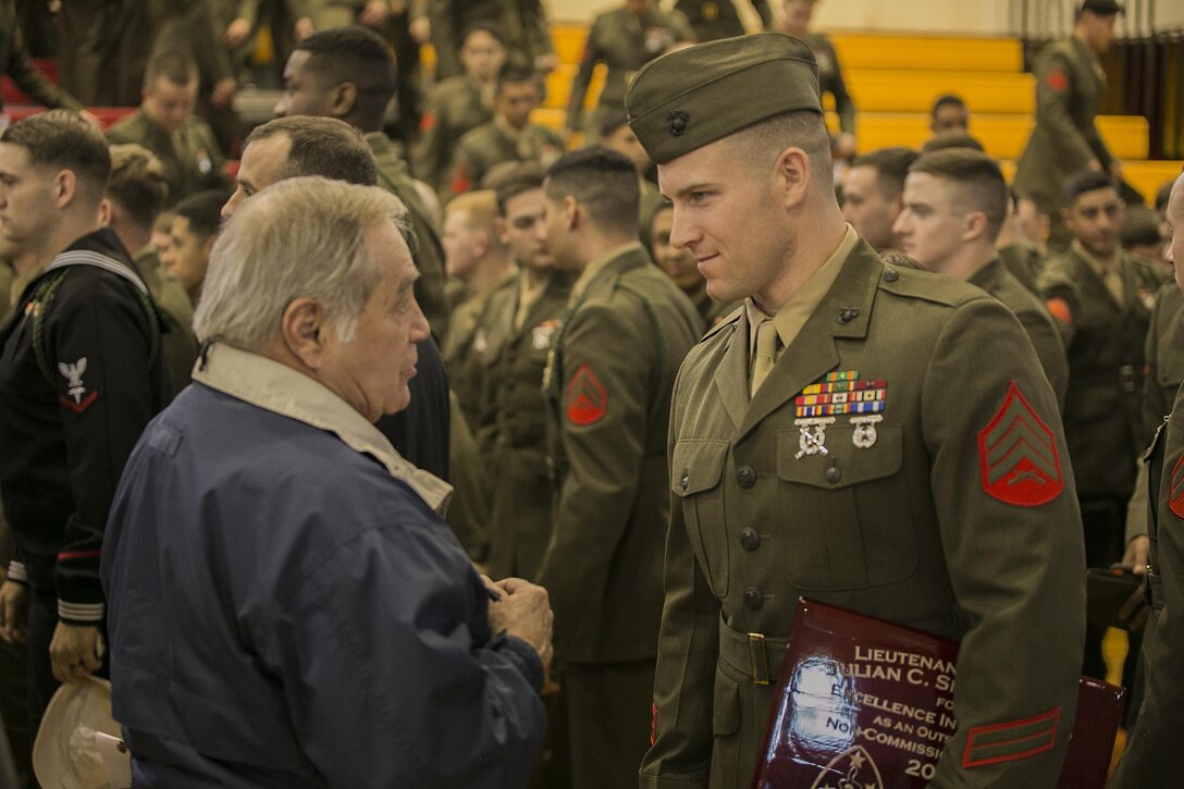 Sgt. John J. Cohee, a noncommissioned officer with 2nd Battalion, 8th Marine Regiment, talks to a veteran who served with the 2nd Marine Division after receiving an award for outstanding leadership at Camp Lejeune, N.C., Feb 5, 2016. The ceremony celebrated the traditions and legacy of the 2nd Marine Division and reinforced the bond between the Marines of wars past and a new generation of Marines. (U.S. Marine Corps photo by Lance Cpl. Luke Hoogendam/Released)