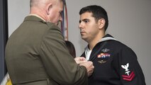 Major Gen. Joseph L. Osterman, commander, U.S. Marine Corps Forces, Special Operations Command, presents Petty Officer 2nd Class Alejandro Salabarria, a corpsman with Marine Special Operations Company F, 2nd Marine Raider Battalion, the Silver Star Medal during a ceremony at Stone Bay, Marine Corps Base Camp Lejeune, North Carolina, Feb. 5, 2016. Salabarria was awarded for his actions in Afghanistan Sept. 15, 2014.