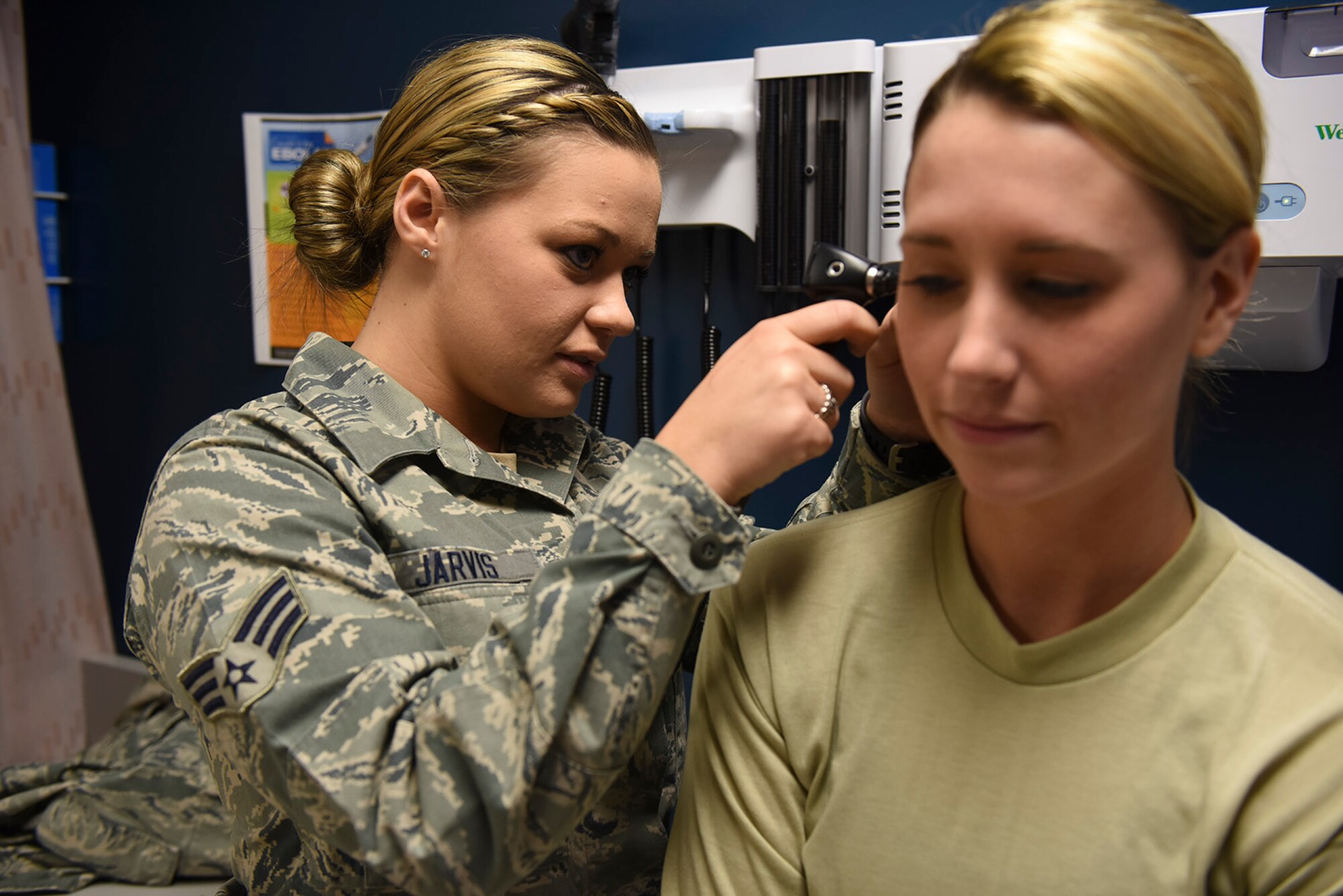 Senior Airman Katherine Jarvis, a medical technician at the 911th Aeromedical Staging Squadron, examines a patient at the Pittsburgh International Airport Air Reserve Station, Feb. 6, 2016. Her civilian career is as a phlebotomist, a health worker trained in drawing blood. (U.S. Air Force photo by Airman Bethany Feenstra)