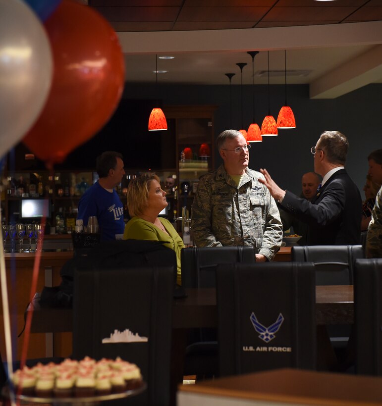 Congressmen Tim Murphy, R-PA 18, speaks with Col. Jeffrey Van Dootingh, 911th Airlift Wing commander, and his wife during social hour at the new community center on Pittsburgh International Airport Air Reserve Station, Feb. 6, 2016. The grand opening of the community unveiled an open concept floor plan, more seating, a new bar, and a gaming zone for Airmen. (U.S. Air Force photo by Staff Sgt. Justyne Obeldobel)