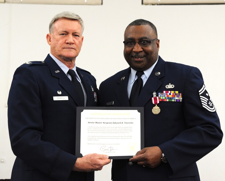 U.S. Air Force Col. Dennis Seymour 927th Mission Support Group commander poses for a photo with Senior Master Sgt. Edward Viverette during his retirement ceremony on Feb. 6, 2016 at MacDill Air Force Base, FL. Viverette retired after 33 years of military service. (U.S. Air Force photo by Senior Airman Xavier Lockley) 
