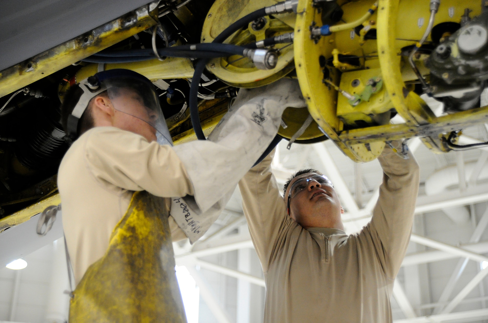 Airmen 1st Class Dalton Smith and Landyn Artman, 22nd Maintenance Squadron hydraulic technicians, remove a KC-135 Stratotanker boom, Feb. 1, 2016, at McConnell Air Force Base, Kan. The inspection is a multi-day event which allows maintenance Airmen to bring the aircraft into the hangar to lift, clean, deconstruct and then reconstruct it to ensure every part on the aircraft is functional. (U.S. Air Force photo/Airman Jenna K. Caldwell)  
