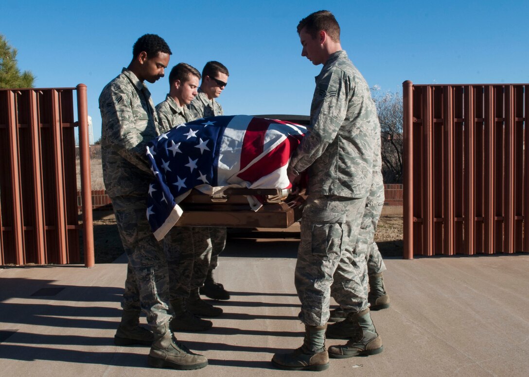 Dyess honor guardsmen practice a pall-bearing sequence Feb. 2, 2016 at Dyess Air Force Base, Texas. The honor guard moves to the hearse in a formation, removes the casket and transfers the casket to the burial site during this sequence using facing movements and commands.  (U.S. Air Force photo by Airman First Class Katherine Miller/Released)