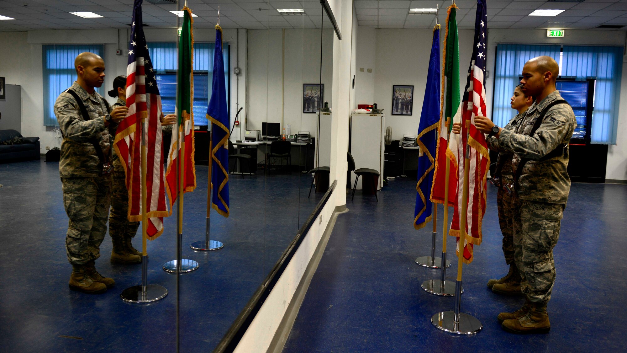 Members of the Aviano Air Base honor guard, present the colors during practice, Feb. 1, 2016, at Aviano Air Base, Italy. Honor guard members here provide a variety of services to the base and local community, including presenting and posting the colors, folding retirement flags and POW/MIA table ceremonies. (U.S. Air Force photo by Senior Airman Areca T. Bell/Released)