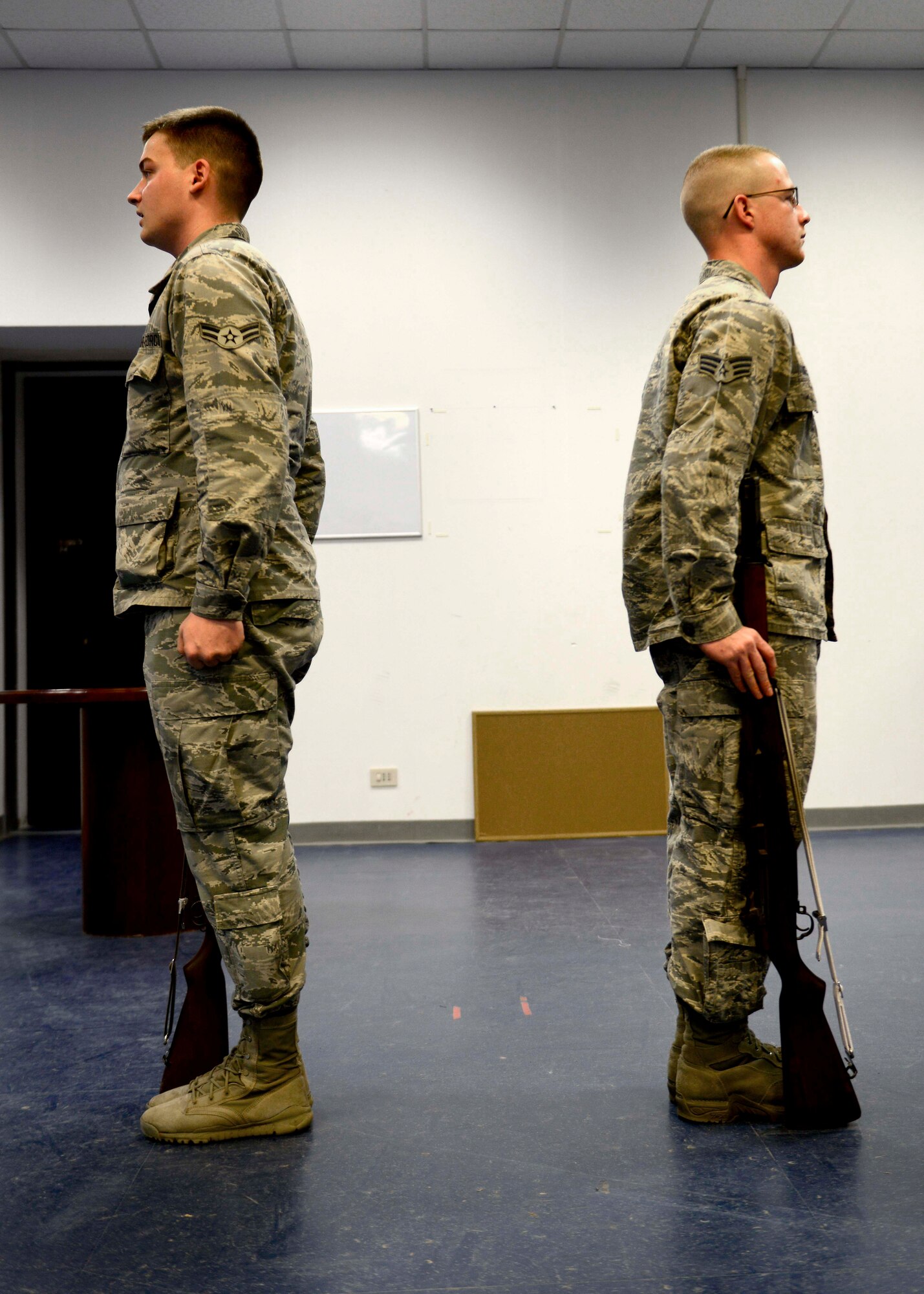 (From left) U.S. Air Force Airman 1st Class Dylan Breese and Senior Airman Zachary Rathbun, Aviano Air Base honor guardsmen, rehearse drills during practice, Feb. 1, 2016, at Aviano Air Base, Italy. Honor guard members here provide a variety of services to the base and local community, including presenting and posting the colors, folding retirement flags and POW/MIA table ceremonies. (U.S. Air Force photo by Senior Airman Areca T. Bell/Released)