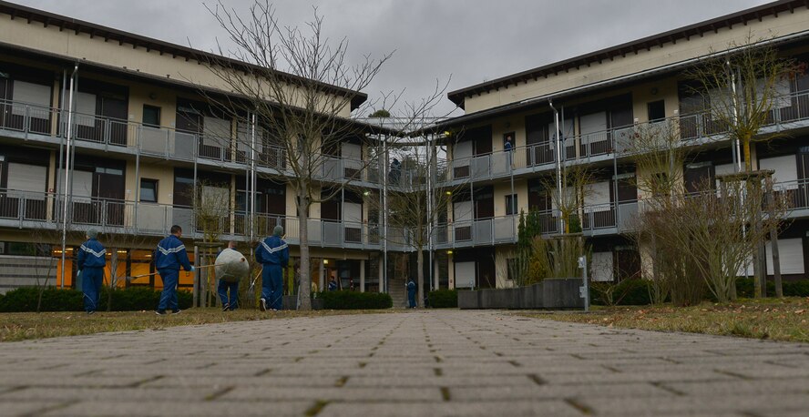 Airmen pick up leaves and trash outside of their living quarters during a dormitory clean-up Jan. 30, 2016, at Ramstein Air Base, Germany. The event kick-started a new base-wide program that will have Airmen from all dormitories helping Airmen Dorm Leaders with their daily cleaning tasks around base while they are on bay orderly for one work week, a program that helps keep Ramstein’s working and living environments pristine. (U.S. Air Force photo/Airman 1st Class Lane T. Plummer)