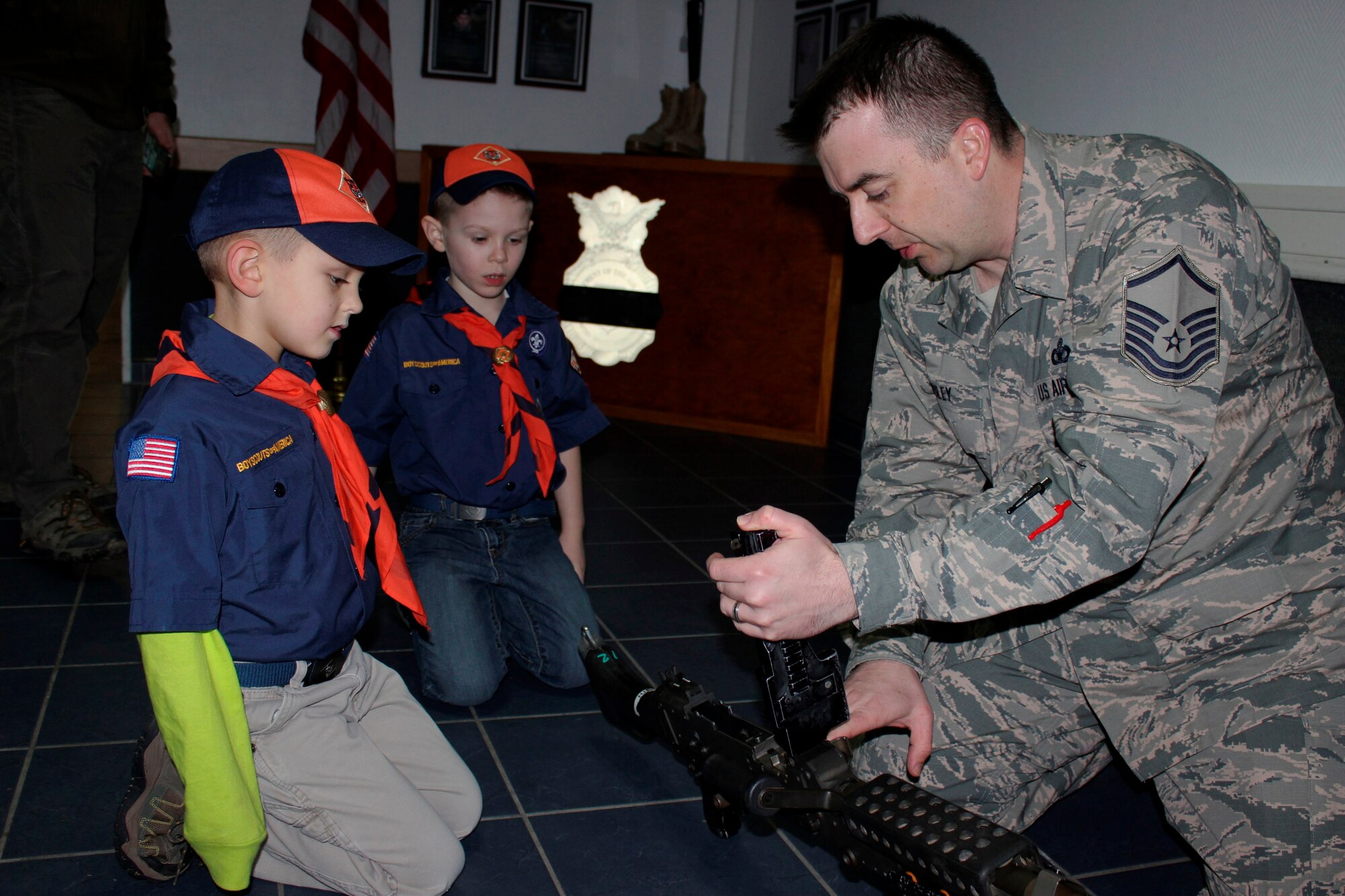 Master Sgt. Gregory Riley, 86th Security Forces Squadron NCO in charge of police services, shows Cub Scouts an M240B Machine Gun Feb. 3, 2016, Ramstein Air Base, Germany. Airmen from the 86th SFS gave local Cub Scouts a tour of their facilities and taught them about some of the weapons they might carry. (U.S. Air Force photo/Tech. Sgt. Robert A. Webb)