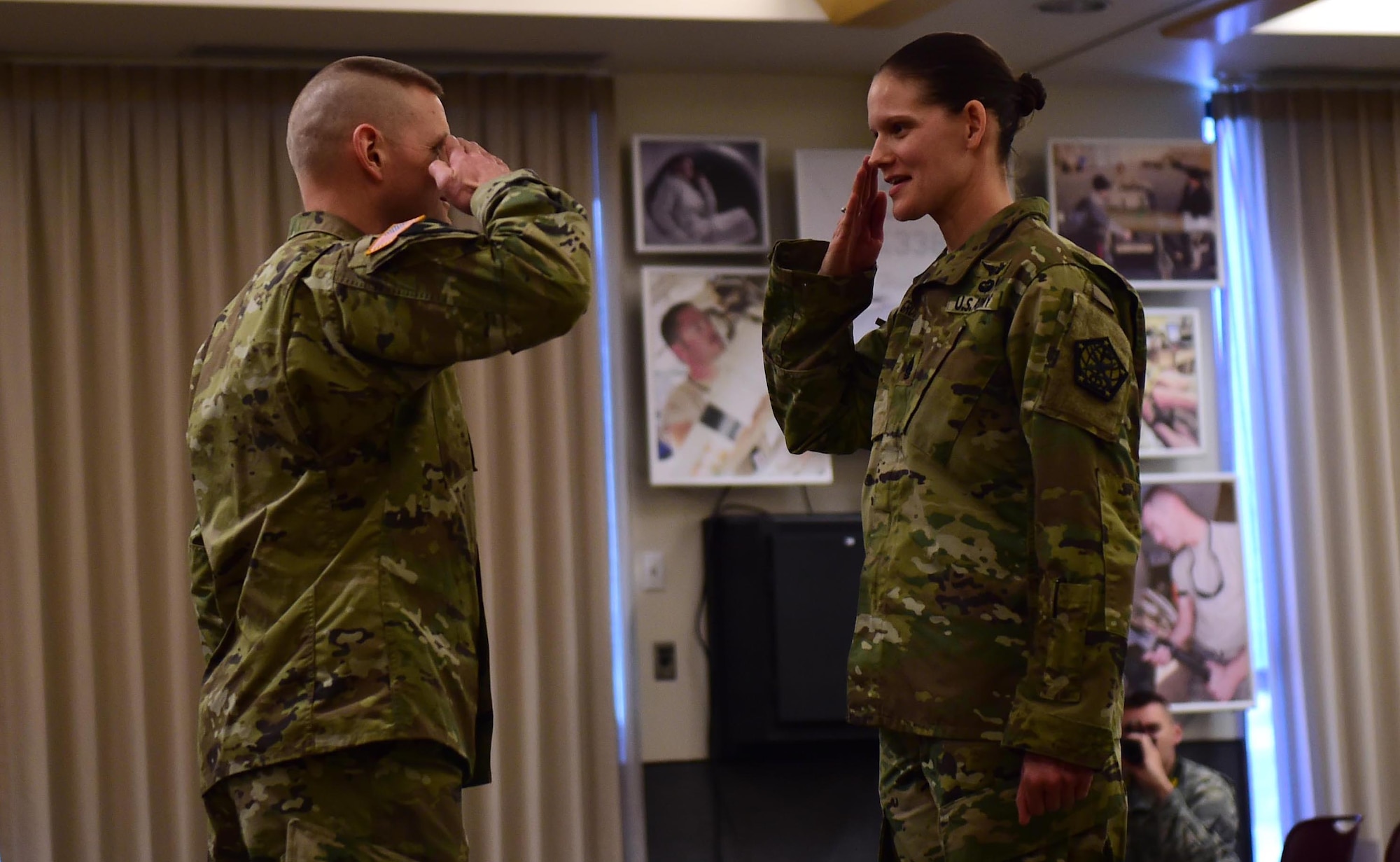 Command Sgt. Maj. Kristin Grover, incoming 743d Military Intelligence Battalion command sergeant major, salutes Sgt. Maj. Garth Newell, commander of troops, before taking command of the battalion Feb. 5, 2016, at Building 706 on Buckley Air Force Base. Command Sgt. Maj. Raymond S. Ramsey, the outgoing 743d MI Battalion command sergeant major, relinquished command to Grover during a change of responsibility ceremony. (U.S. Air Force photo by Airman 1st Class Gabrielle Spradling/Released)