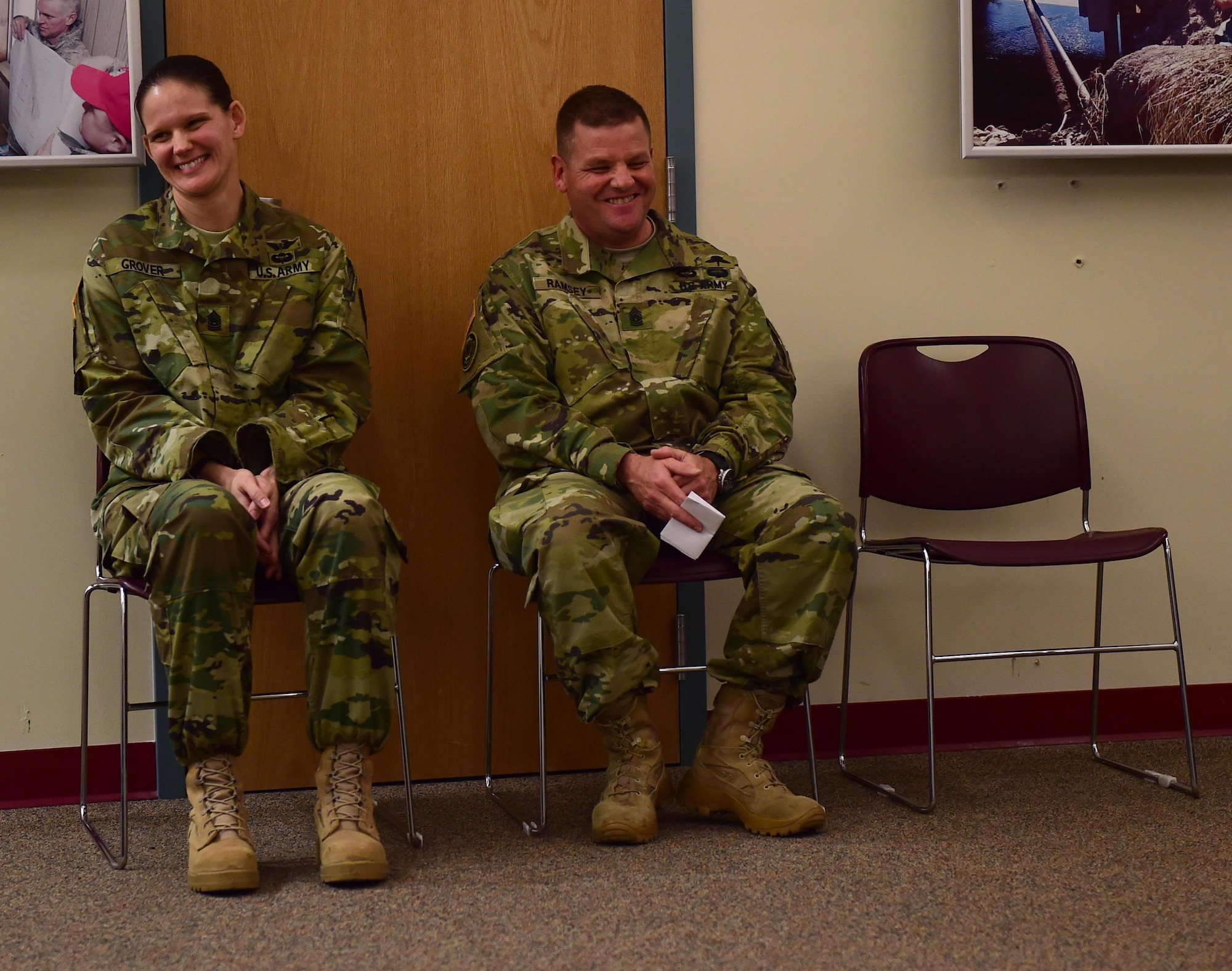Command Sgt. Maj. Kristin Grover, incoming 743d Military Intelligence Battalion command sergeant major, and Command Sgt. Maj. Raymond S. Ramsey, the outgoing 743d MI Battalion command sergeant major, laugh during a speech Feb. 5, 2016 at Building 706 on Buckley Air Force Base. Ramsey relinquished command to Grover during a change of responsibility ceremony. (U.S. Air Force photo by Airman 1st Class Gabrielle Spradling/Released)