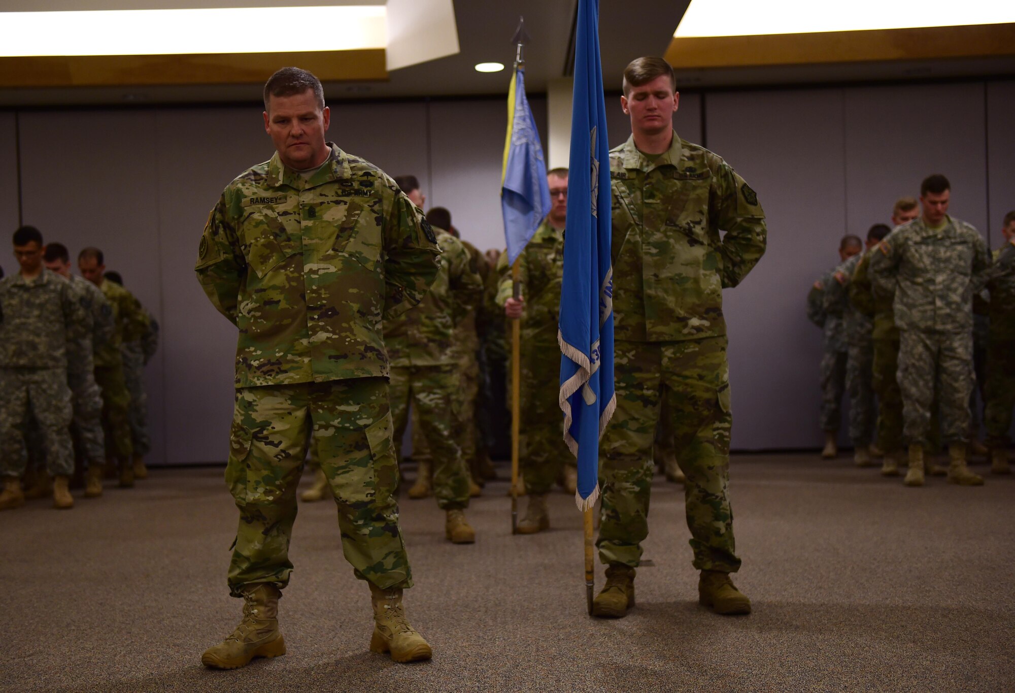 Command Sgt. Maj. Raymond S. Ramsey, outgoing 743d Military Intelligence Battalion command sergeant major, stands silently during a prayer Feb. 5, 2016, at Building 706 on Buckley Air Force Base. Ramsey relinquished command to Command Sgt. Maj. Kristin Grover, incoming 743d MI Battalion command sergeant major, during a change of responsibility ceremony. (U.S. Air Force photo by Airman 1st Class Gabrielle Spradling/Released)