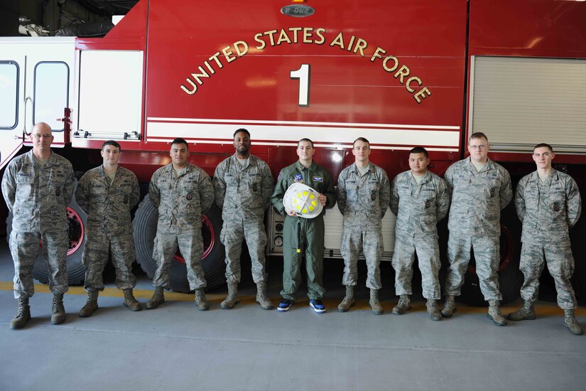 Michael Oliver, Pilot for a Day participant, poses for a group photo with fire fighters from the 11th Civil Engineer Squadron at Joint Base Andrews, Md., Feb. 5, 2016. Oliver, diagnosed with Erdheim-Chester Disease, a disease with no known cure, experienced what it is like to be a pilot for a day along with friends and family. The day included touring an assortment of aircraft including an F-16 Fighting Falcon, KC-135 Stratotanker and a UH-1N Huey helicopter. (U.S. Air Force photo by Senior Airman Dylan Nuckolls/Released)