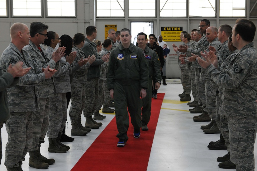 Michael Oliver, Pilot for a Day participant, is greeted by Airmen from the 113th Maintenance Group at Joint Base Andrews, Md., Feb. 5, 2016. Oliver, diagnosed with Erdheim-Chester Disease, a disease with no known cure, experienced what it is like to be a pilot for a day along with friends and family. The day included touring an assortment of aircraft including an F-16 Fighting Falcon, KC-135 Stratotanker and a UH-1N Huey helicopter. (U.S. Air Force photo by Senior Airman Dylan Nuckolls/Released)