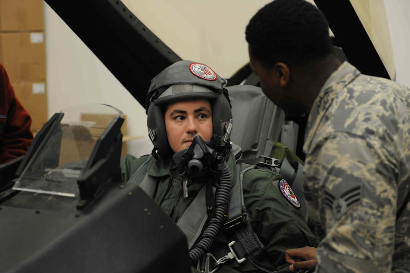 Michael Oliver, Pilot for a Day participant, receives an F-16 Fighting Falcon fighter aircraft safety briefing from a 113th Operation Support Squadron, aircrew flight technician at Joint Base Andrews, Md., Feb. 5, 2016. Oliver, diagnosed with Erdheim-Chester Disease, a disease with no known cure, experienced what it is like to be a pilot for a day along with friends and family. The day included touring an assortment of aircraft including an F-16 Fighting Falcon, KC-135 Stratotanker and a UH-1N Huey helicopter. (U.S. Air Force photo by Senior Airman Dylan Nuckolls/Released)