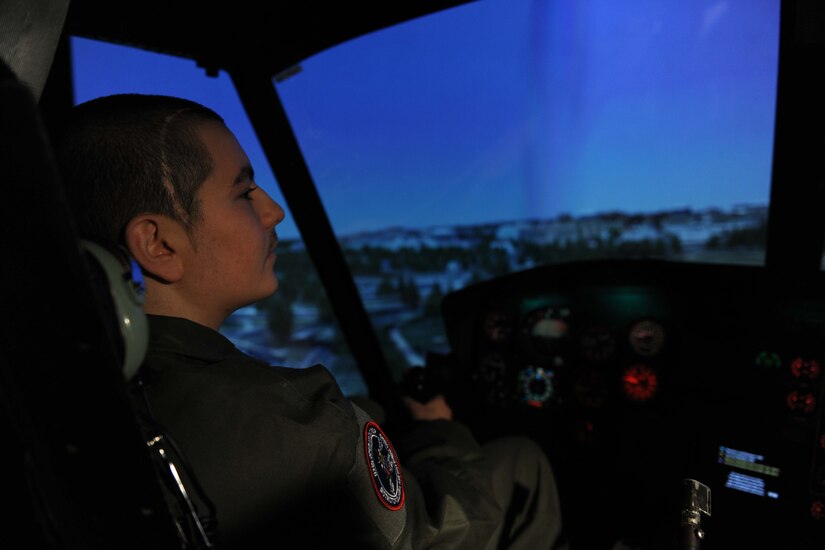 Michael Oliver, Pilot for a Day participant, flies in the UH-1N Huey helicopter simulator at Joint Base Andrews, Md., Feb. 5, 2016. Oliver, diagnosed with Erdheim-Chester Disease, a disease with no known cure, experienced what it is like to be a pilot for a day along with friends and family. The day included touring an assortment of aircraft including an F-16 Fighting Falcon, KC-135 Stratotanker and a UH-1N Huey helicopter. (U.S. Air Force photo by Senior Airman Dylan Nuckolls/Released)