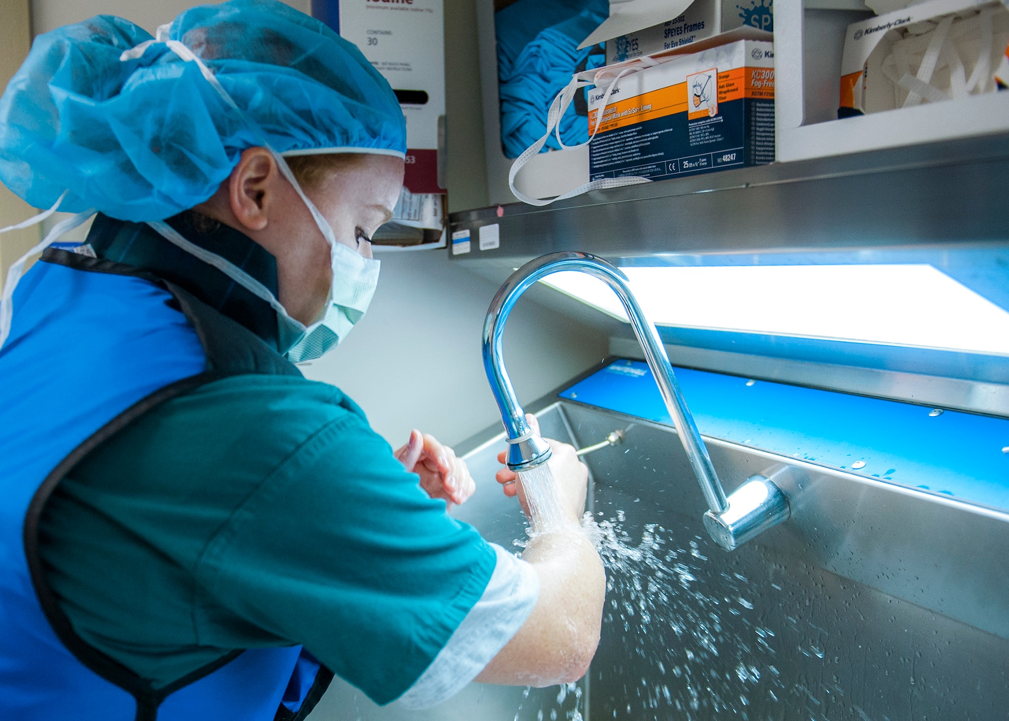 Senior Airman Samantha Bautista, a 96th Medical Operations Squadron cardio pulmonary technician, washes her forearms in the scrub area at Eglin Hospital, Jan. 14 at Eglin Air Force Base, Fla. Bautista prepared to assist doctors during a cardiac catheterization. Eglin’s newest invasive imaging procedure allows doctors to identify how well a patient’s blood flows to the artery that feeds the heart. (U.S. Air Force photo/Ilka Cole) 