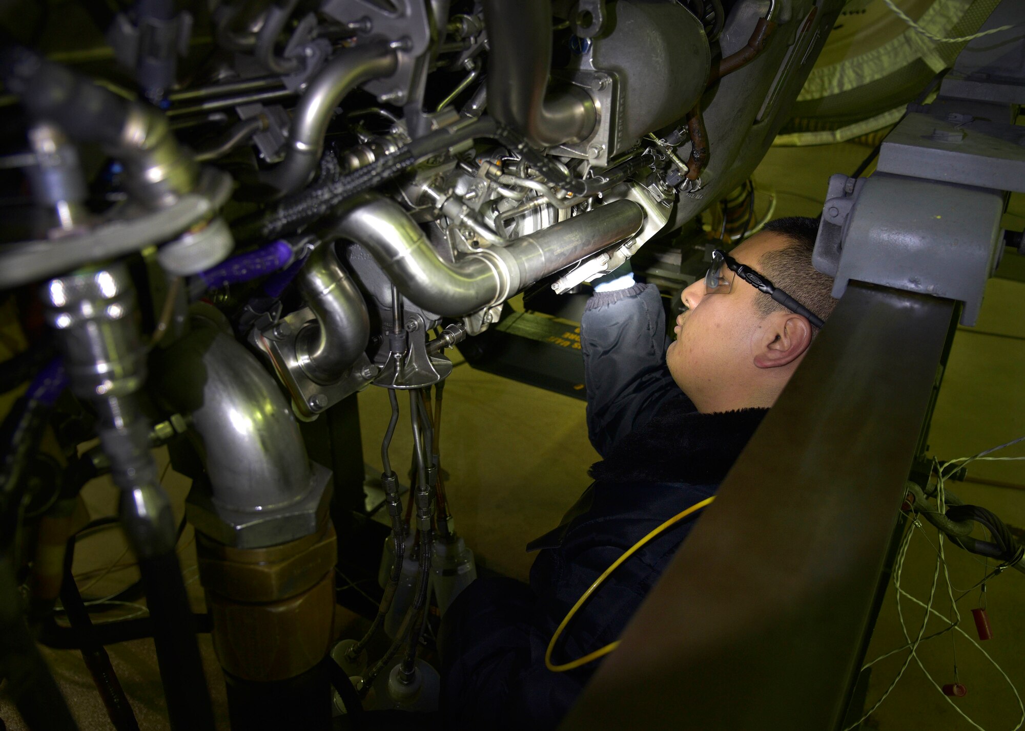 U.S. Air Force Senior Airman Daniel San Miguel, an aerospace propulsion journeyman with the 35th Maintenance Squadron, removes an oil sample from an F110-GE-129 engine after a test performance at Misawa Air Base, Japan, Feb. 4, 2016. Weekly, propulsion Airmen tests one to two engines from here, Osan and Kunsan Air Base, Republic of Korea. San Miguel hails from Oceanside, California. (U.S. Air Force photo by Senior Airman Deana Heitzman)