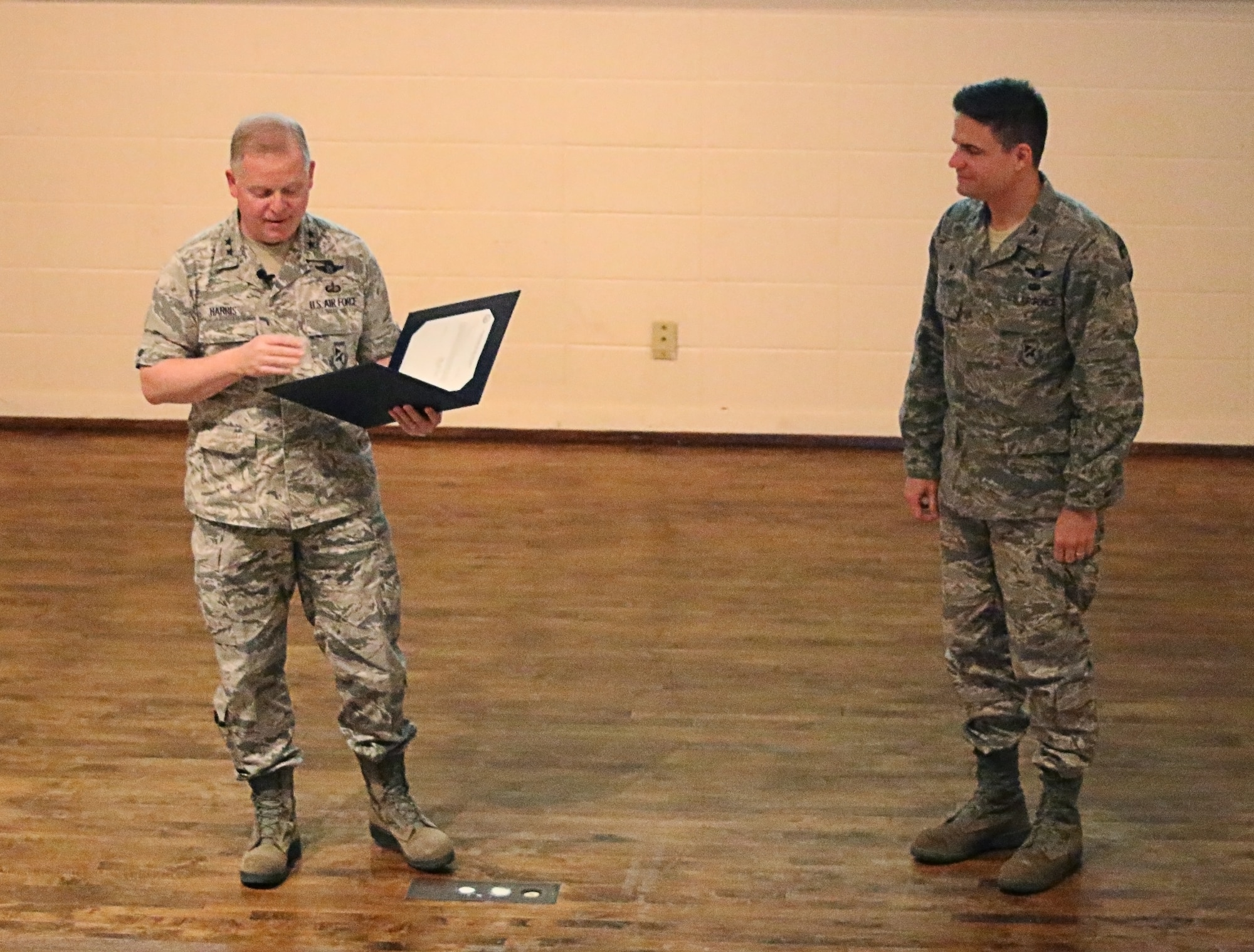 Maj. Gen. David Harris, commander of the Air Force Test Center, presents the Air Force Organization Excellence Award for 2015 for the exceptionally meritorious service performed at AEDC from June 1, 2013, to May 31, 2015, to AEDC Commander Col. Rodney Todaro. (U.S. Air Force Photo/Holly Fowler)