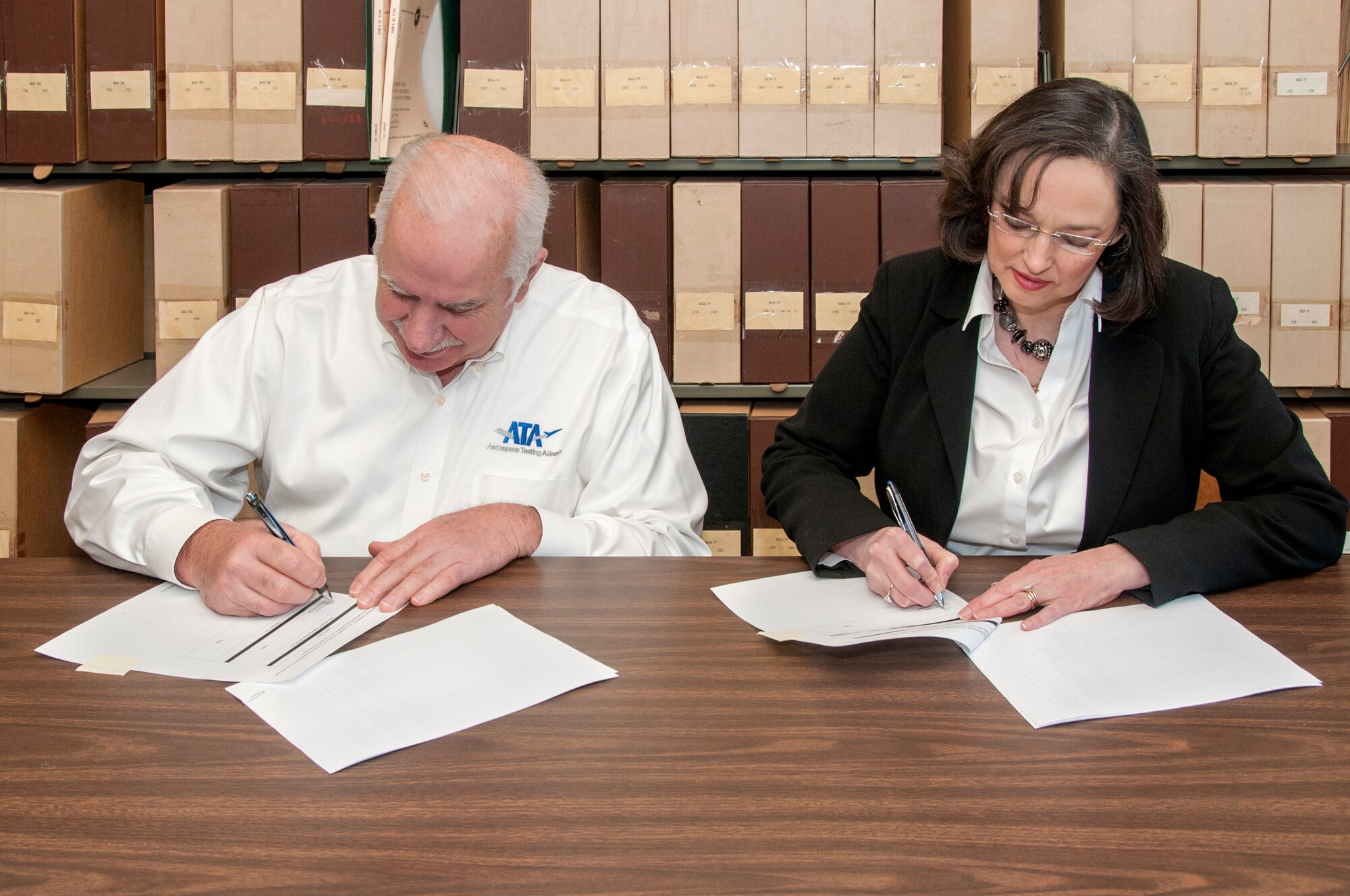 OBXtek, Inc. Program Manager Theresa Cates (right) and ATA General Manager Steve Pearson sign the ATA/OBXtek, Inc. Associate Contractor Agreement on Jan. 29 at AEDC. This agreement outlines how ATA and OBXtek will coordinate work activities. OBXtek was awarded the Base Communications and Information Technology Services (BCITS) contract for Arnold Air Force Base June 19. OBXtek began contracting operations on Feb. 1 which include performing base communication and information technology services at Arnold Air Force Base and its two geographically separated units in Maryland and California. (U.S. Air Force photo/Jacqueline Cowan)