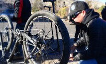 A Ride 2 Recovery mechanic inspects a bike before a mountain bike ride Feb. 2, 2016, at Blue Diamond, Nevada. R2R is a groundbreaking veteran program that saves lives by restoring hope and purpose by reaching out to veterans through cycling as a therapy for injuries, Post-Traumatic Stress Disorder, Traumatic Brain Injuries (TBI) and creates a family for them to be a part of again. (U.S. Air Force photo by Senior Airman Christian Clausen/Released)