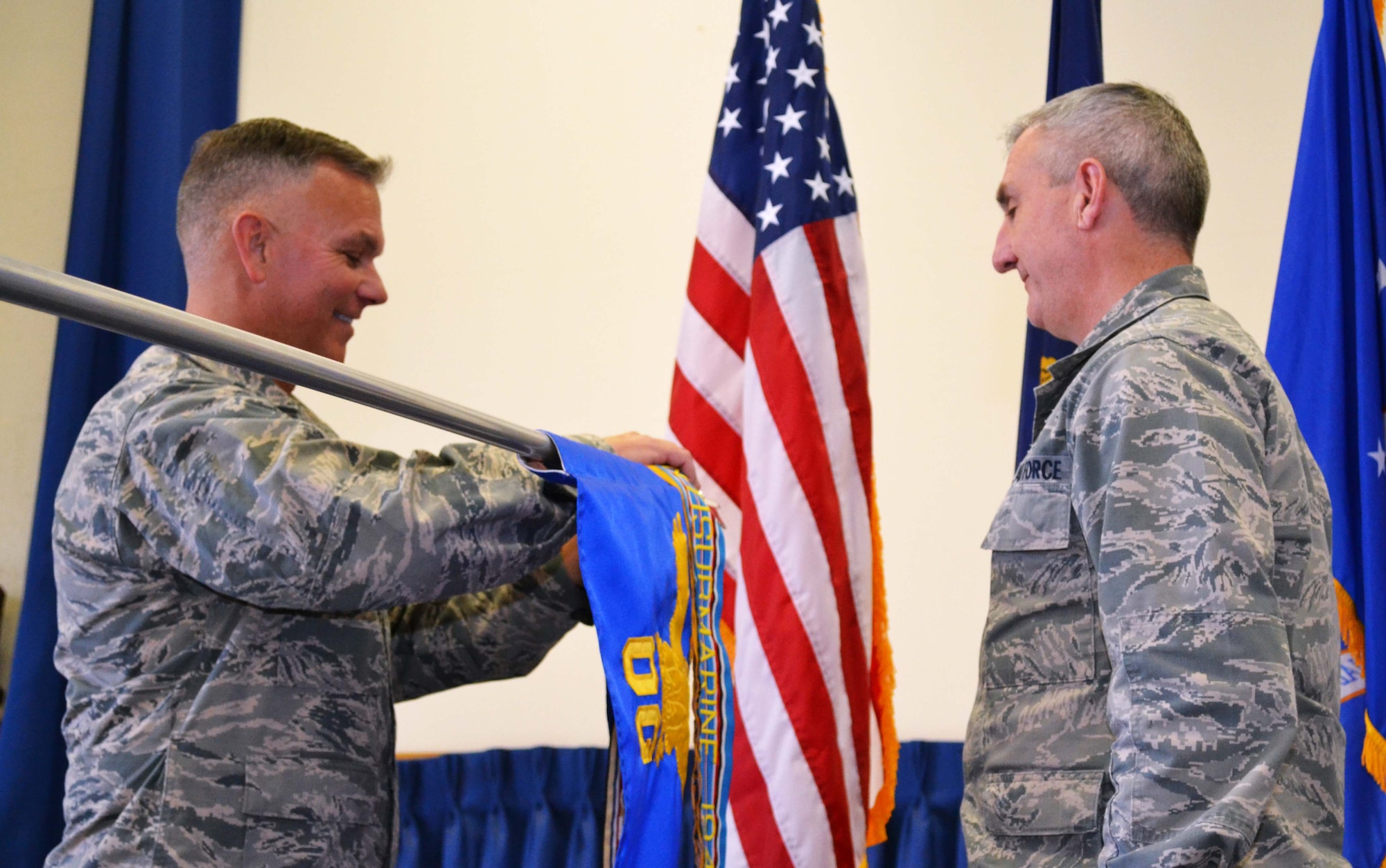 Col. Thomas James, left, 111th Air Operations Group commander, removes the 111th AOG streamer from the 111th Operations Group guidon in order to hand it to the 111th Attack Wing Commander Col. Howard Eissler during the 111th AOG deactivation ceremony held Feb. 6, 2016 at Horsham Air Guard Station, Pennsylvania. After five years of high-tempo operations, the 111th AOG will be officially deactivated this March. (U.S. Air National Guard photo by Tech. Sgt. Andria Allmond)
