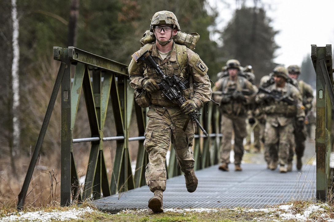 Army Spc. Shane Rader runs during a 12-mile ruck march as part of the testing phase for the expert infantryman badge at the 7th Army Joint Multinational Training Command’s Grafenwoehr Training Area, Germany, Feb. 5, 2016. Bader is a paratrooper assigned to Company C, 2nd Battalion, 503rd Infantry Regiment, 173rd Airborne Brigade. The brigade provides rapidly deploying forces to the U.S. Army Europe, Africa and Central Command areas of responsibility within 18 hours. Army photo by Gertrud Zach