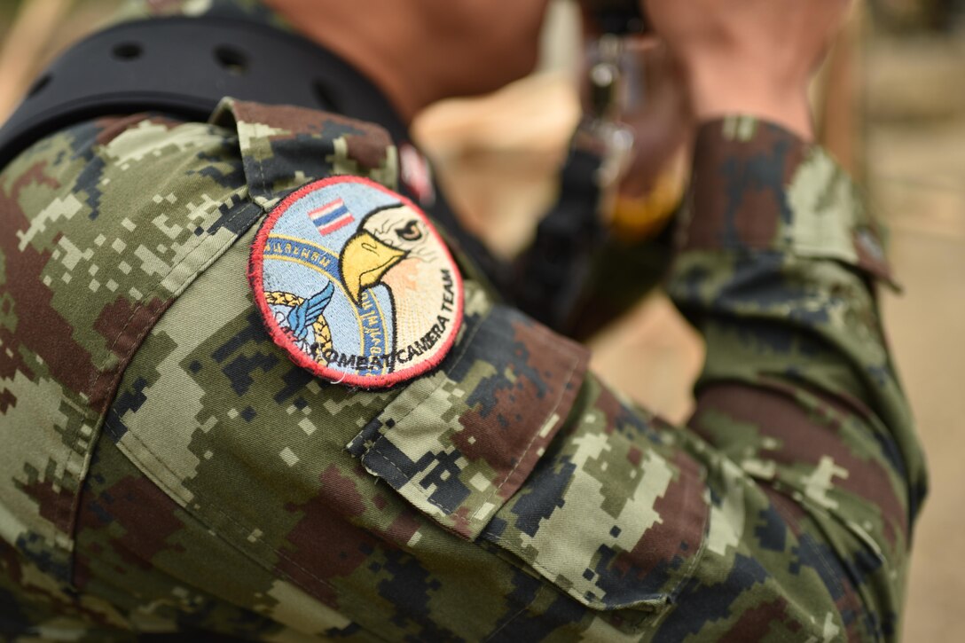Service members from the Royal Thai Armed Forces, Singapore Army, People's Republic of China, People's Liberation Army,U.S. Air Force and local community members attend a pillar raising ceremony at the Wuat Ban Mak school, during exercise Cobra Gold 2016, Saraburi, Thailand, Jan. 25, 2016. Cobra Gold, in its 35th iteration, focuses on humanitarian civic action, community engagement, and medical activities to support the needs and humanitarian interest of civilian populations around the region.