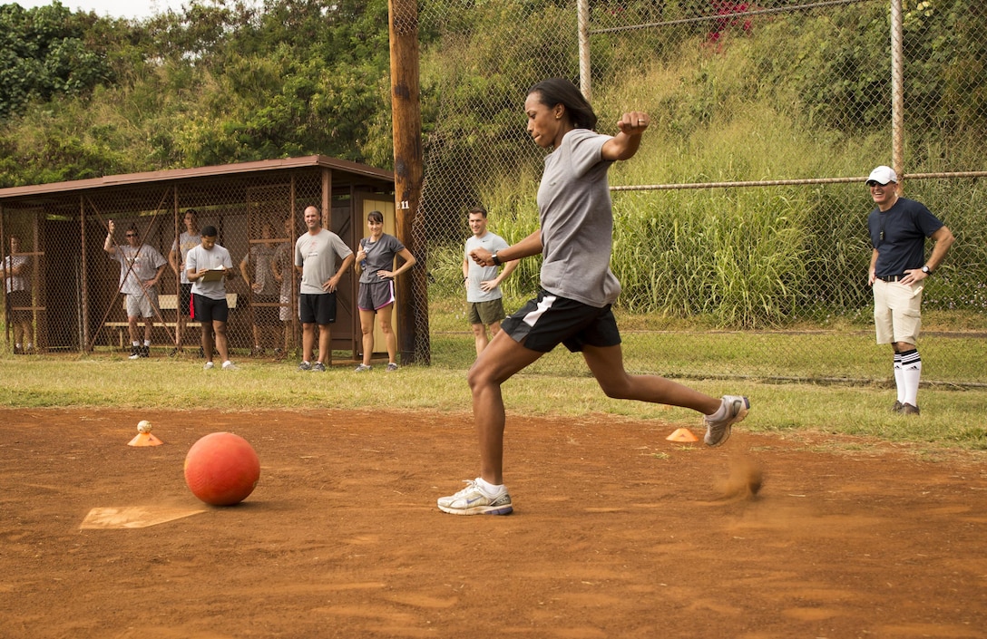 Christina R. Henry boots the ball during a kickball game on Bordelon Field aboard Camp H. M. Smith, Hawaii, Feb. 5, 2016. Officers and staff noncommissioned officers faced off in a team-building event held quarterly to compete, build camaraderie and increase Esprit de Corps.