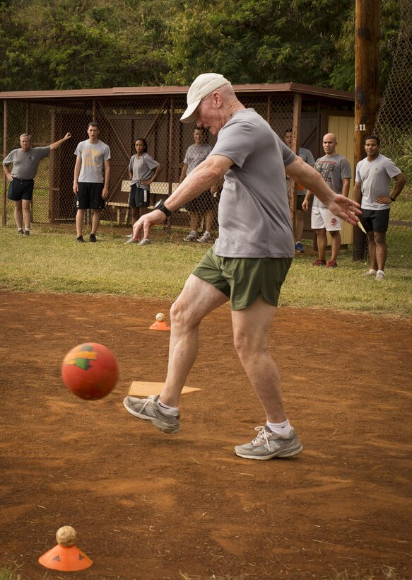 Lt. Gen. John A. Toolan, U.S. Marine Corps Forces, Pacific commander, sends the ball toward the outfield during a kickball game on Bordelon Field,Camp H. M. Smith, Hawaii, Feb. 5, 2016. Officers and staff noncommissioned officers faced off in a team-building event held quarterly to compete, build camaraderie and increase Esprit de Corps. 