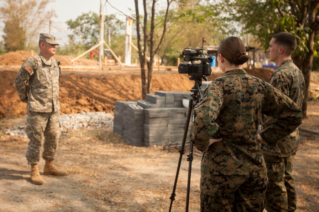 U.S. Marine Corps Lance Cpl. Megan Boulrice and Sgt. William Holdaway (right), combat videographers with U.S. Marine Corps Forces, Pacific, interview U.S. Army  Staff Sgt. Brad Barnett at Ban Raj Bum Roong in Lop Buri, Thailand, exercise Cobra Gold, Jan. 23, 2016. Cobra Gold 2016, in its 35th iteration, includes a specific focus on humanitarian civic action, community engagement and medical activities conducted during the exercise to support the needs and humanitarian interests of civilian populations around the region.