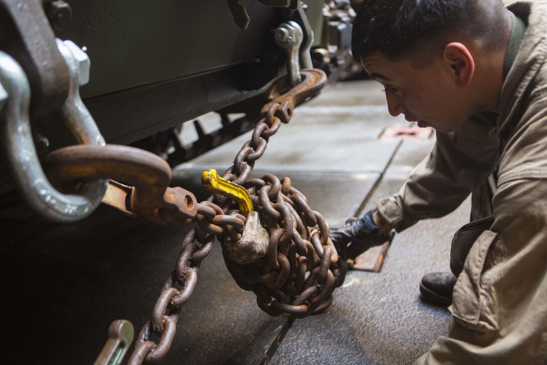 A Marine with Alpha Company, Battalion Landing Team 1st Battalion, 5th Marines, 31st Marine Expeditionary Unit, secures an AAV-P7/A1 Amphibious Assault Vehicle to the well-deck of the USS Ashland (LSD 48) Jan. 29, 2016, at White Beach, Okinawa, Japan. The Marines loaded their AAVs onto the Ashland before departing for the MEU's spring deployment. The spring deployment is a regularly scheduled deployment designed to support PACOM's theater security cooperation initiatives to promote goodwill, and strengthen allied relationships. 