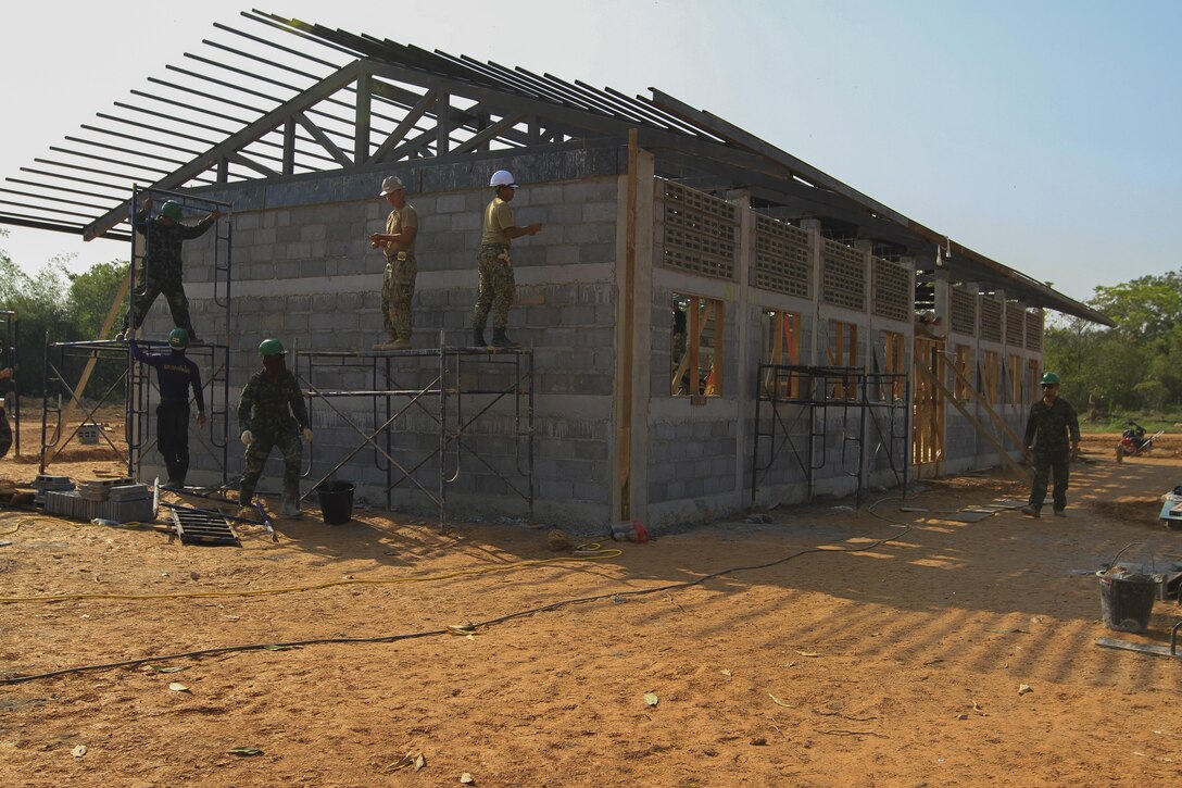 Service members from the Royal Thai Armed Forces, Malaysia Armed Forces and the U.S. Navy work together to build a community center at Ban Sa Yai School, in Trat, Thailand, during exercise Cobra Gold, Feb. 3, 2016. Cobra Gold 2016, in its 35th iteration, includes a specific focus on humanitarian civic action, community engagement and medical activities conducted during the exercise to support the needs and humanitarian interests of civilian populations around the region.