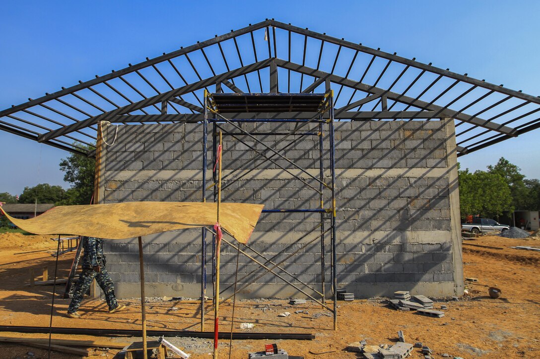 Service members from the Royal Thai Armed Forces, Malaysia Armed Forces and the U.S. Navy work together to build a community center at Ban Sa Yai School, in Trat, Thailand, during exercise Cobra Gold, Feb. 3, 2016. Cobra Gold 2016, in its 35th iteration, includes a specific focus on humanitarian civic action, community engagement and medical activities conducted during the exercise to support the needs and humanitarian interests of civilian populations around the region. (U.S. Marine Corps Combat Camera photo by Lance Cpl. Miguel A. Rosales/Released)