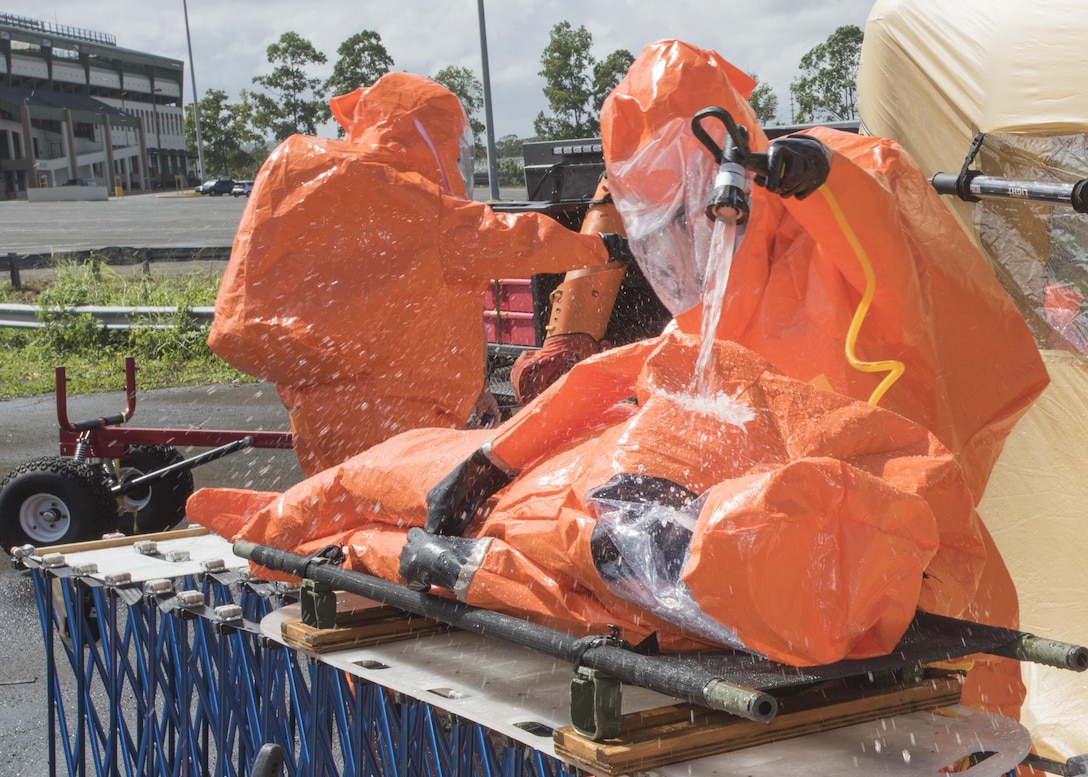 Army Staff Sgt. Rusty Greeno, right, rinses Air Force Tech. Sgt. August Hoaglund during decontamination for a man-down drill during proficiency training at Roberto Clemente Stadium in Carolina, Puerto Rico, Jan. 26, 2016. Greeno and Hoaglund are survey team chiefs assigned to the Vermont National Guard’s 15th Civil Support Team. Vermont Army National Guard photo by Staff Sgt. Nathan Rivard