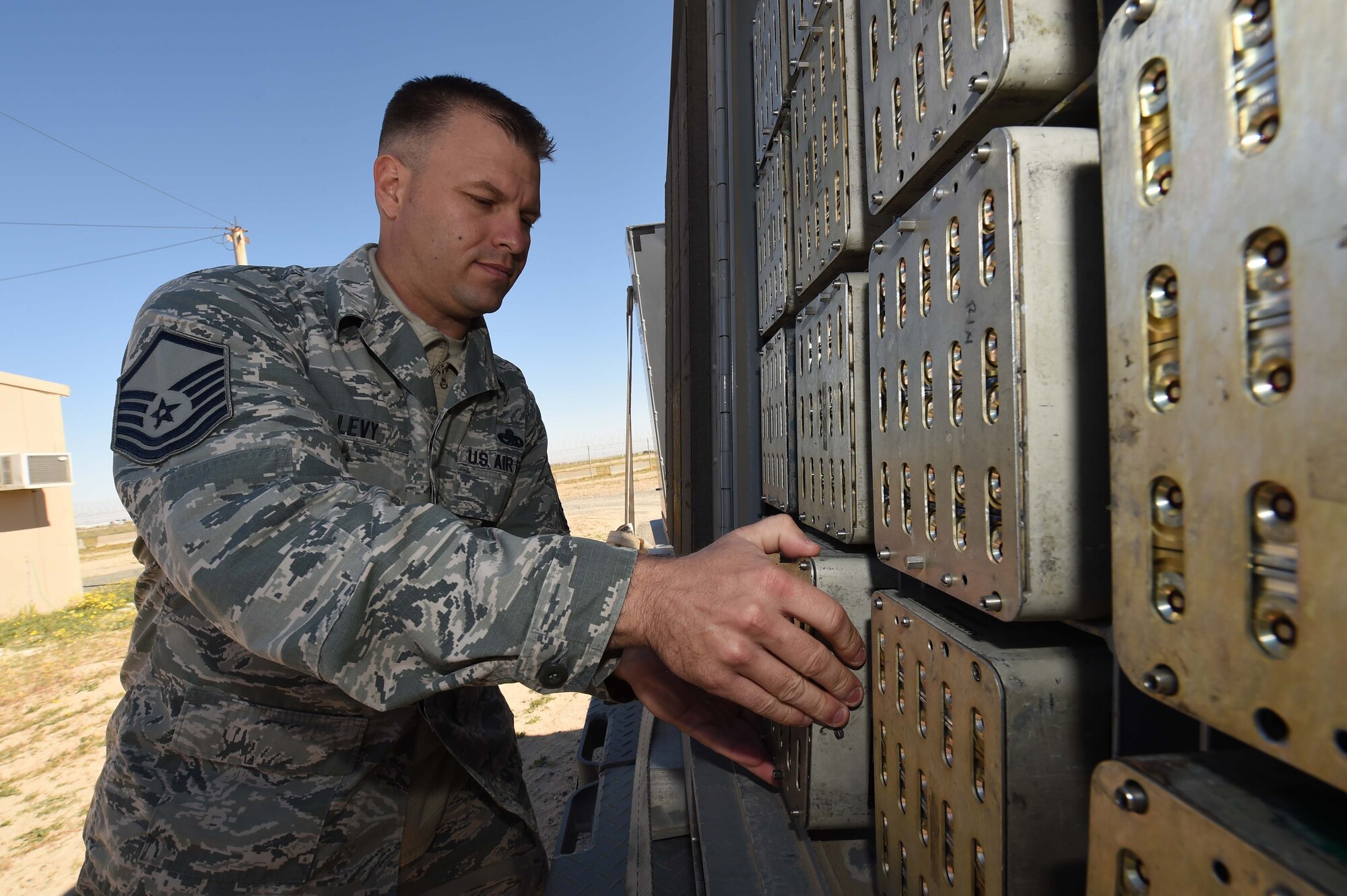 Master Sgt. Wayne Levy, 386th Munitions Flight production chief, loads chaff and flare modules onto a munitions trailer at an undisclosed location in Southwest Asia, Jan. 29, 2016. The munitions flight is responsible for testing, building and delivering munitions in support of the fight against ISIL. (U.S. Air Force photo by Staff Sgt. Jerilyn Quintanilla)