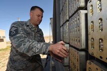 Master Sgt. Wayne Levy, 386th Munitions Flight production chief, loads chaff and flare modules onto a munitions trailer at an undisclosed location in Southwest Asia, Jan. 29, 2016. The munitions flight is responsible for testing, building and delivering munitions in support of the fight against ISIL. (U.S. Air Force photo by Staff Sgt. Jerilyn Quintanilla)