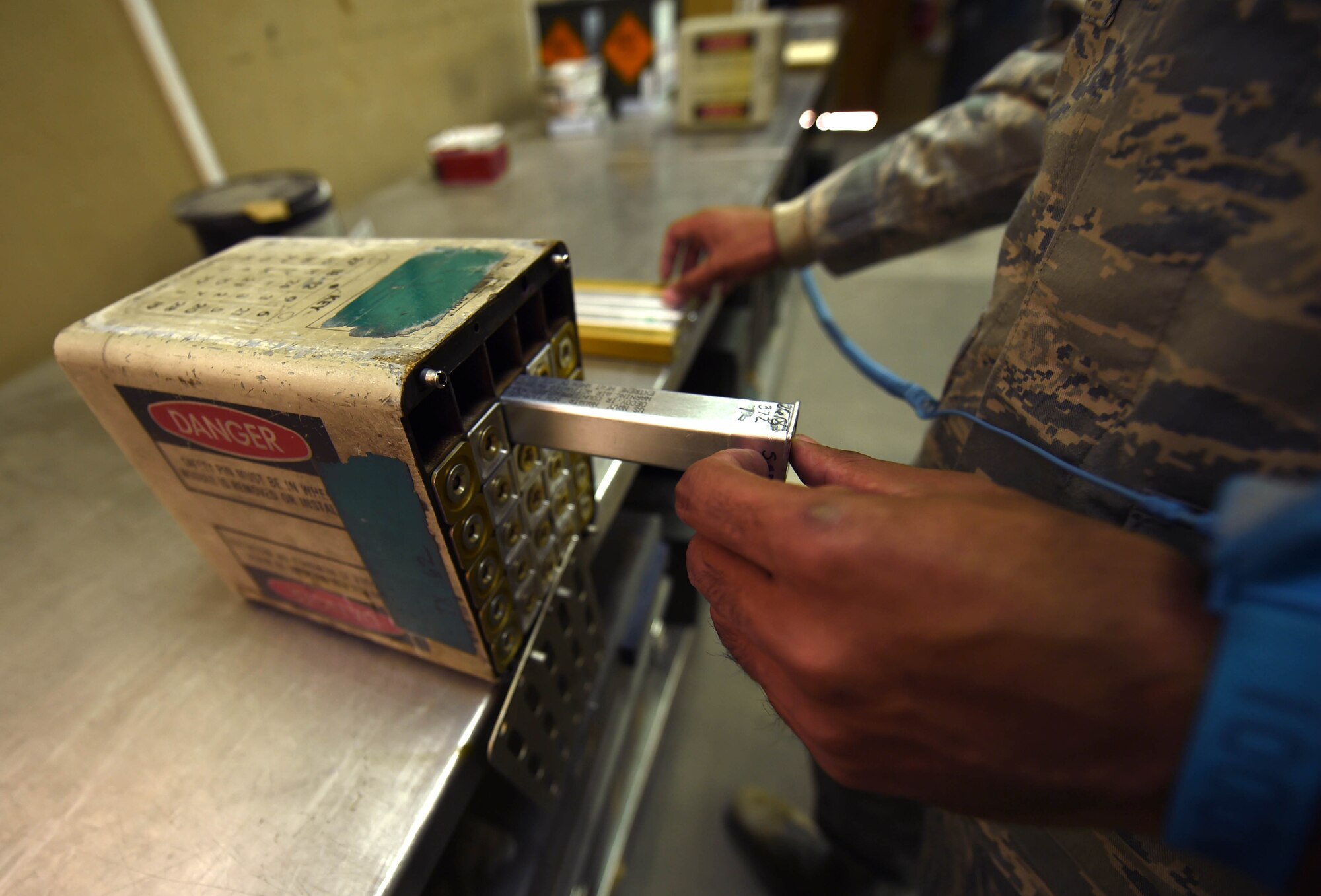Staff Sgt. Eduardo Caraballo, 386th Munitions Flight munitions crew chief, re-stuffs a flare module at an undisclosed location in Southwest Asia, Jan. 29, 2016. The munitions flight mission is to test, build and deliver precise munitions to U.S. and coalition aircraft in support of Operation INHERENT RESOLVE. (U.S. Air Force photo by Staff Sgt. Jerilyn Quintanilla)