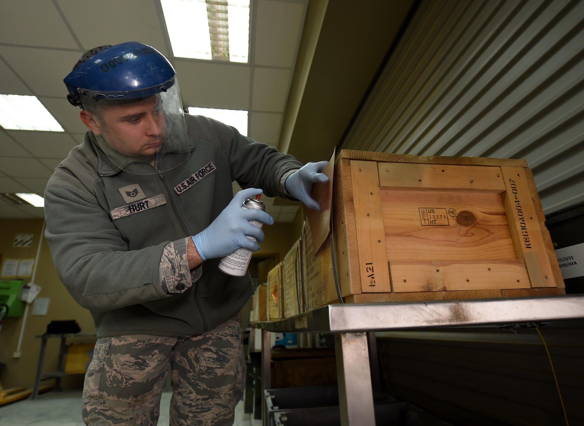 Staff Sgt. James Hurt, 386th Munitions Flight senior munitions inspector, inspects and changes the condition identity on a crate of munitions at an undisclosed location in Southwest Asia, Jan. 29, 2016. The munitions flight mission is to test, build and deliver precise munitions to U.S. and coalition aircraft in support of Operation INHERENT RESOLVE. (U.S. Air Force photo by Staff Sgt. Jerilyn Quintanilla)