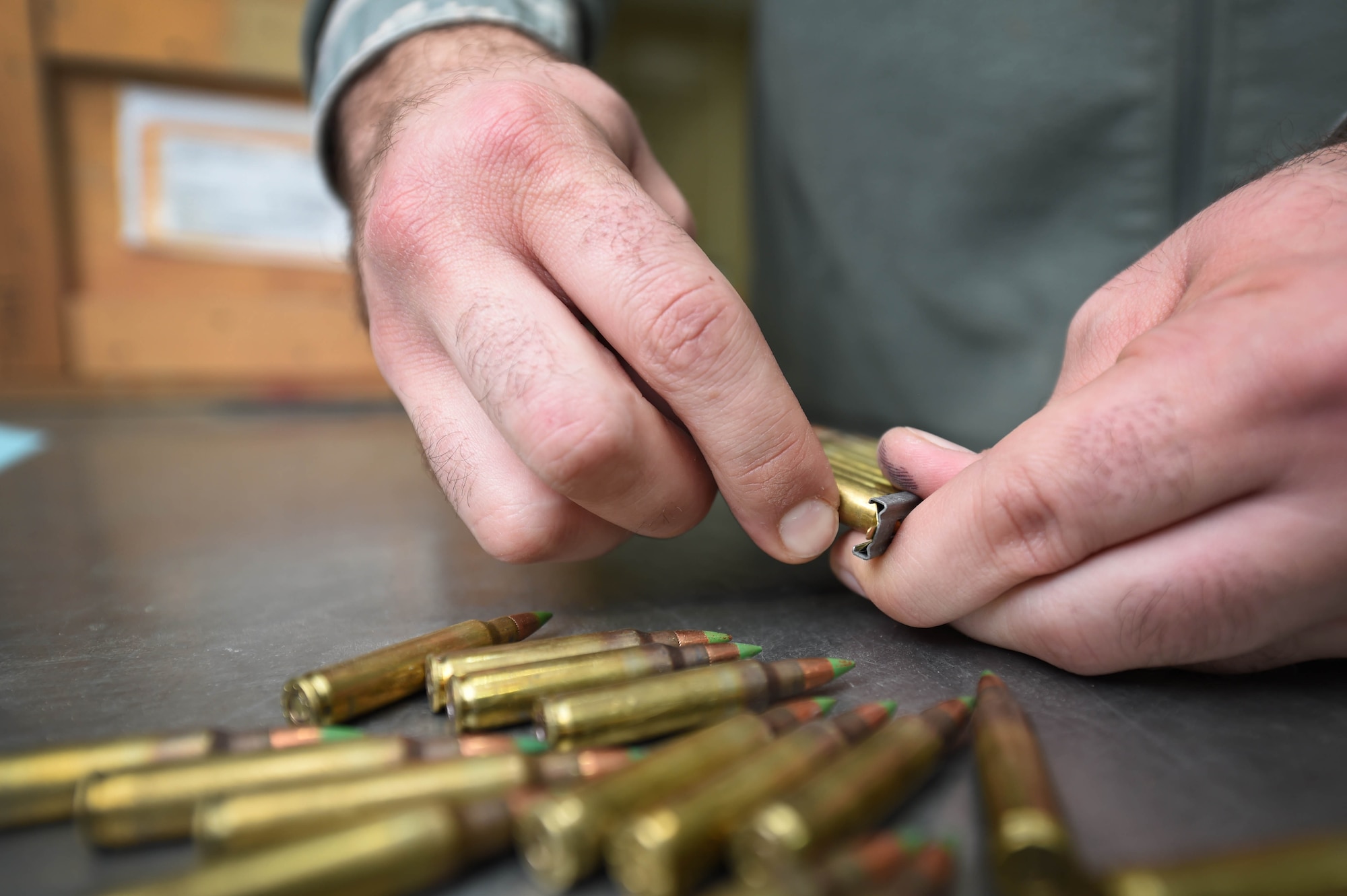 Staff Sgt. James Hurt, 386th Munitions Flight senior munitions inspector, verifies and re-links 5.56 rounds at an undisclosed location in Southwest Asia, Jan. 29, 2016. The flight maintains all munitions used throughout the installation including the 5.56 rounds which are primarily used by security forces personnel. (U.S. Air Force photo by Staff Sgt. Jerilyn Quintanilla)