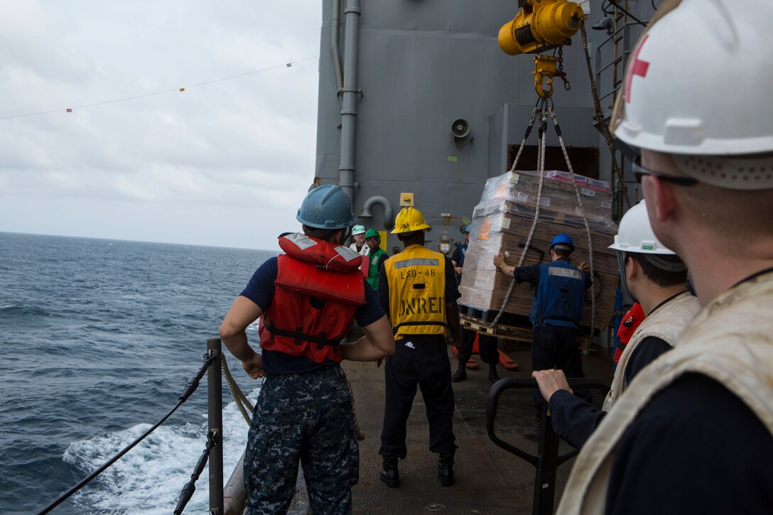 U.S. sailors on board the USS Ashland (LSD 48) pull in cargo from the USNS John Ericsson at sea Feb. 4, 2016. The Ashland recently went underway with the 31st Marine Expeditionary Unit Marines and sailors as part of the MEU’s spring deployment, a regularly scheduled deployment designed to support PACOM's theater security cooperation initiatives to promote goodwill, and strengthen allied relationships.
