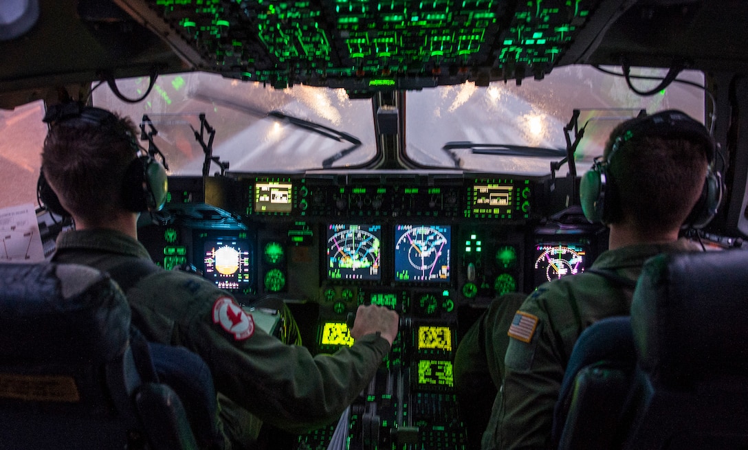 Air Force Capts. Christopher Gilbert, left, and Roderick Mills land a C-17 Globemaster III at Pope Army Airfield, N.C., Feb. 4, 2015, after a mission to support "large package week," which involves dropping large equipment and paratroopers onto drop zones at Fort Bragg, N.C. Gilbert and Mills are pilots assigned to the 517th Airlift Squadron, 3rd Airlift Wing, deployed from Joint Base Elmendorf-Richardson, Alaska. Large package week prepares Army and Air Force units for worldwide crisis and contingency operations. Air Force photo by Staff Sgt. Gregory Brook