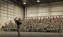 Col. James Phillips, 919th Special Operations Wing commander, makes a grand entrance into the wing’s annual awards ceremony as part of a security forces fire team.  The colonel and his team entered and tossed out stress balls to the Airmen in the crowd on the right side of the room.  Chief Master Sgt. Brian Bischoff, the wing's command chief, did the same with another fire team on the left side to begin the event.  (U.S. Air Force photo/Tech. Sgt. Sam King) 