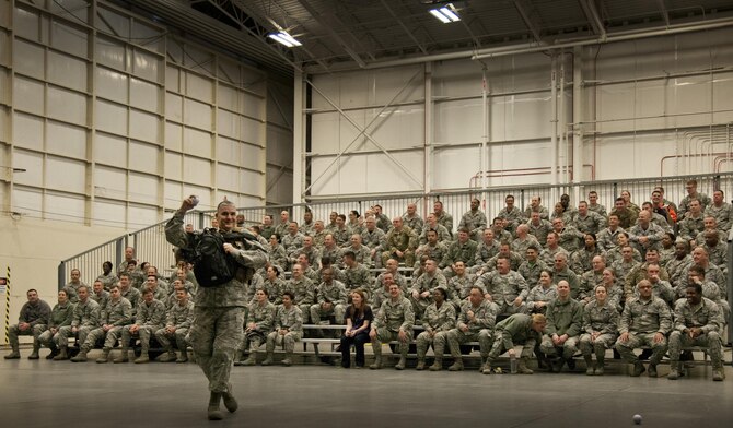 Col. James Phillips, 919th Special Operations Wing commander, makes a grand entrance into the wing’s annual awards ceremony as part of a security forces fire team.  The colonel and his team entered and tossed out stress balls to the Airmen in the crowd on the right side of the room.  Chief Master Sgt. Brian Bischoff, the wing's command chief, did the same with another fire team on the left side to begin the event.  (U.S. Air Force photo/Tech. Sgt. Sam King) 