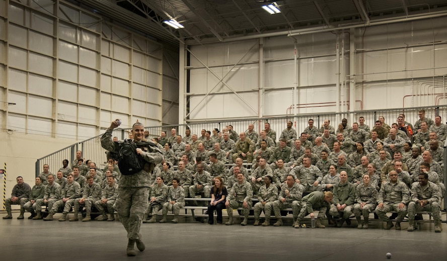 Col. James Phillips, 919th Special Operations Wing commander, makes a grand entrance into the wing’s annual awards ceremony as part of a security forces fire team.  The colonel and his team entered and tossed out stress balls to the Airmen in the crowd on the right side of the room.  Chief Master Sgt. Brian Bischoff, the wing's command chief, did the same with another fire team on the left side to begin the event.  (U.S. Air Force photo/Tech. Sgt. Sam King) 