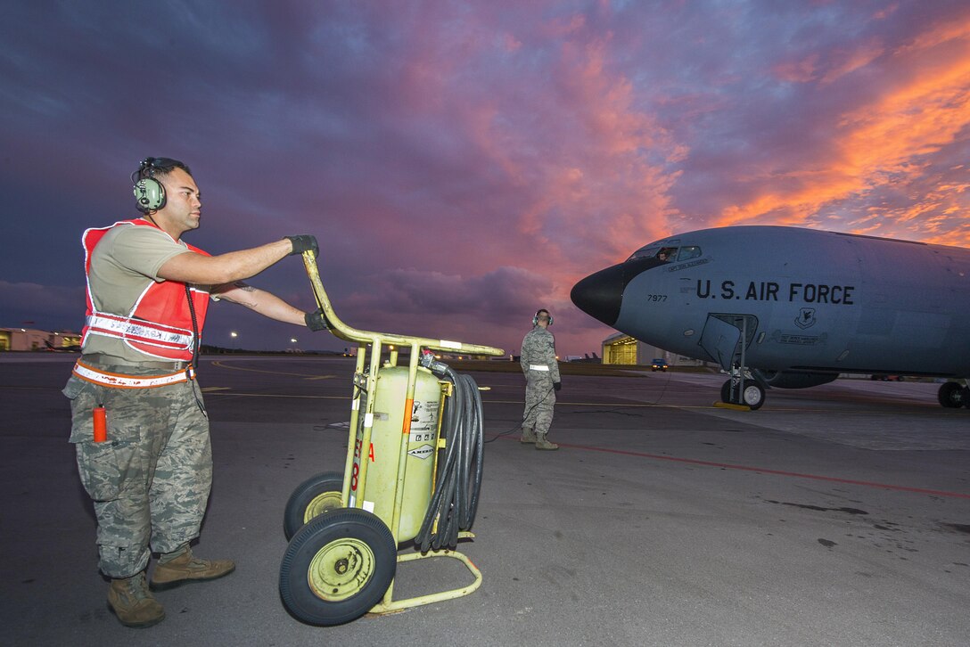 Airmen prepare a KC-135 Stratotanker for takeoff during Forceful Tiger at Kadena Air Base, Japan, Jan. 28, 2016. The airmen are crew chiefs assigned to the 909th Aircraft Maintenance Unit. Forceful Tiger is an annual exercise designed to demonstrate the 18th Wing's combat capabilities in the region. Air Force photo by Staff Sgt. Maeson L. Elleman
