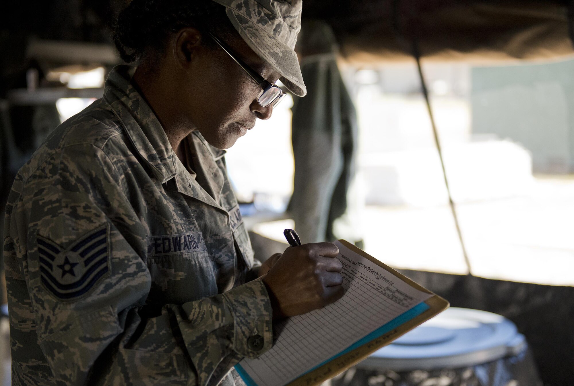 Tech. Sgt. Sharon Edwards, 919th Special Operations Force Support Squadron, completes a production log in the unit’s field kitchen Feb. 7 at Duke Field Fla.  The kitchen was erected and used as part of the 919th SOFSS flight’s Hennessy Award inspection.  The Airmen cooked and served lunch to customers from the constructed kitchen.  (U.S. Air Force photo/Tech. Sgt. Jasmin Taylor)