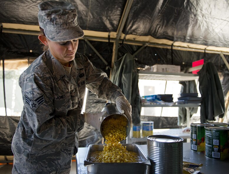 Senior Airman Haylee Jones, 919th Special Operations Force Support Squadron, pours corn into a pan in the unit’s field kitchen Feb. 7 at Duke Field Fla.  The kitchen was erected and used as part of the 919th SOFSS flight’s Hennessy Award inspection.  The Airmen cooked and served lunch to customers from the constructed kitchen.  (U.S. Air Force photo/Tech. Sgt. Jasmin Taylor)